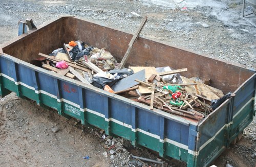 Company van collecting commercial bins at a business site