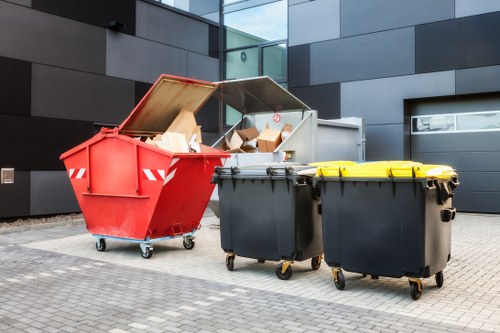 Warehouse clearance crew measuring cubic yards of mixed waste